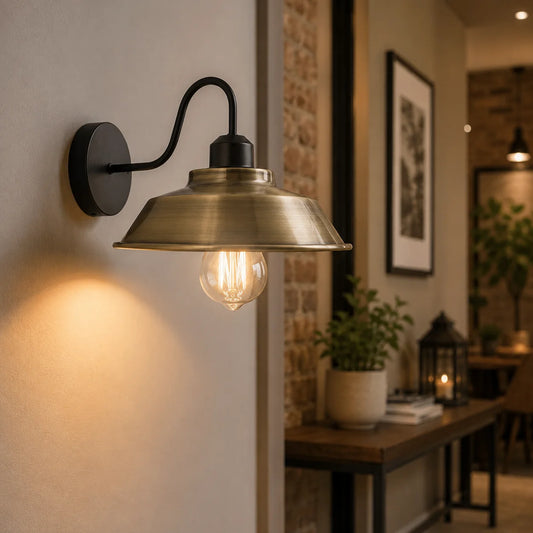 Brass wall-mounted light fixture in a cozy room setting.