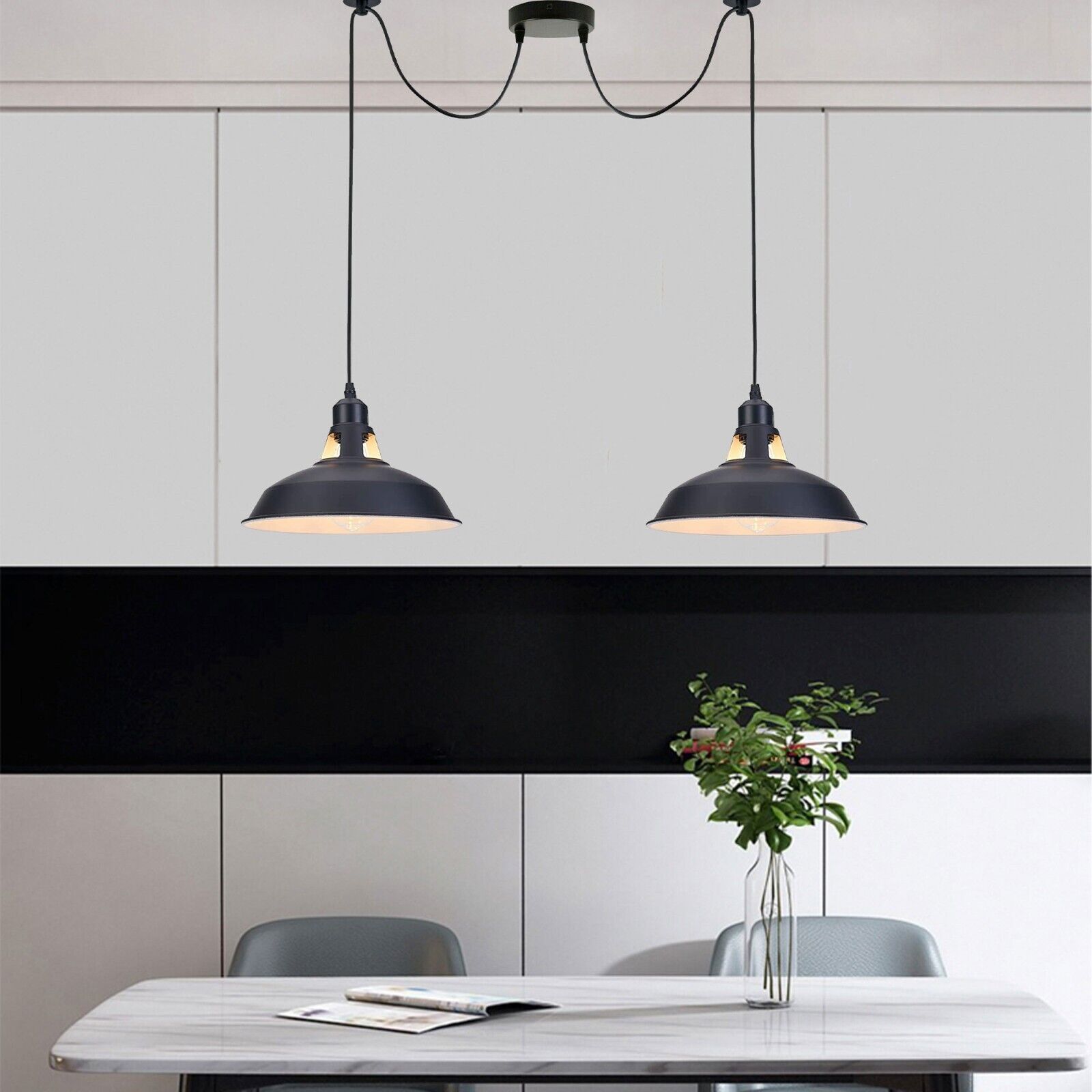 Two pendant lights illuminate a dining table, creating a warm and inviting atmosphere for meals.