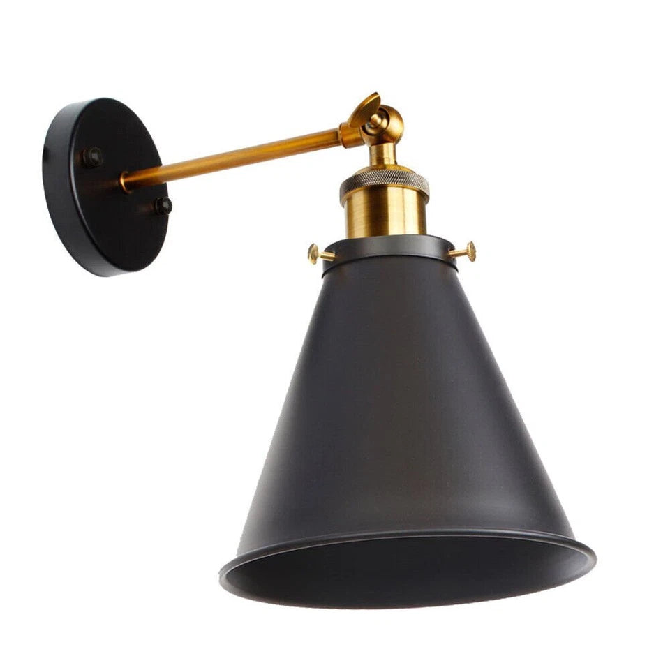 A retro industrial wall light featuring an adjustable gold-tone arm, a black metal cone-shaped shade, and a circular wall mount, set against a plain white background.