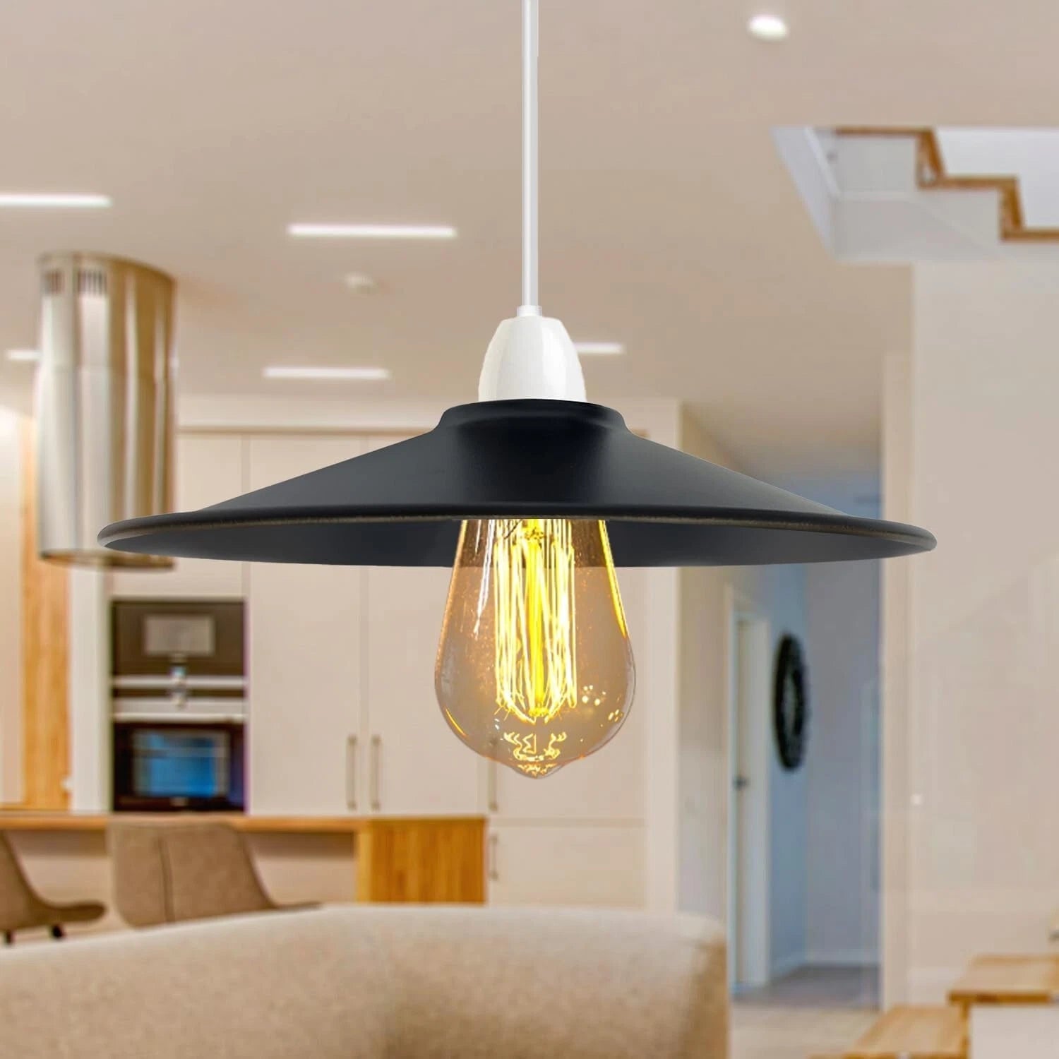 Black pendant light with a glowing yellow bulb in a modern interior setting