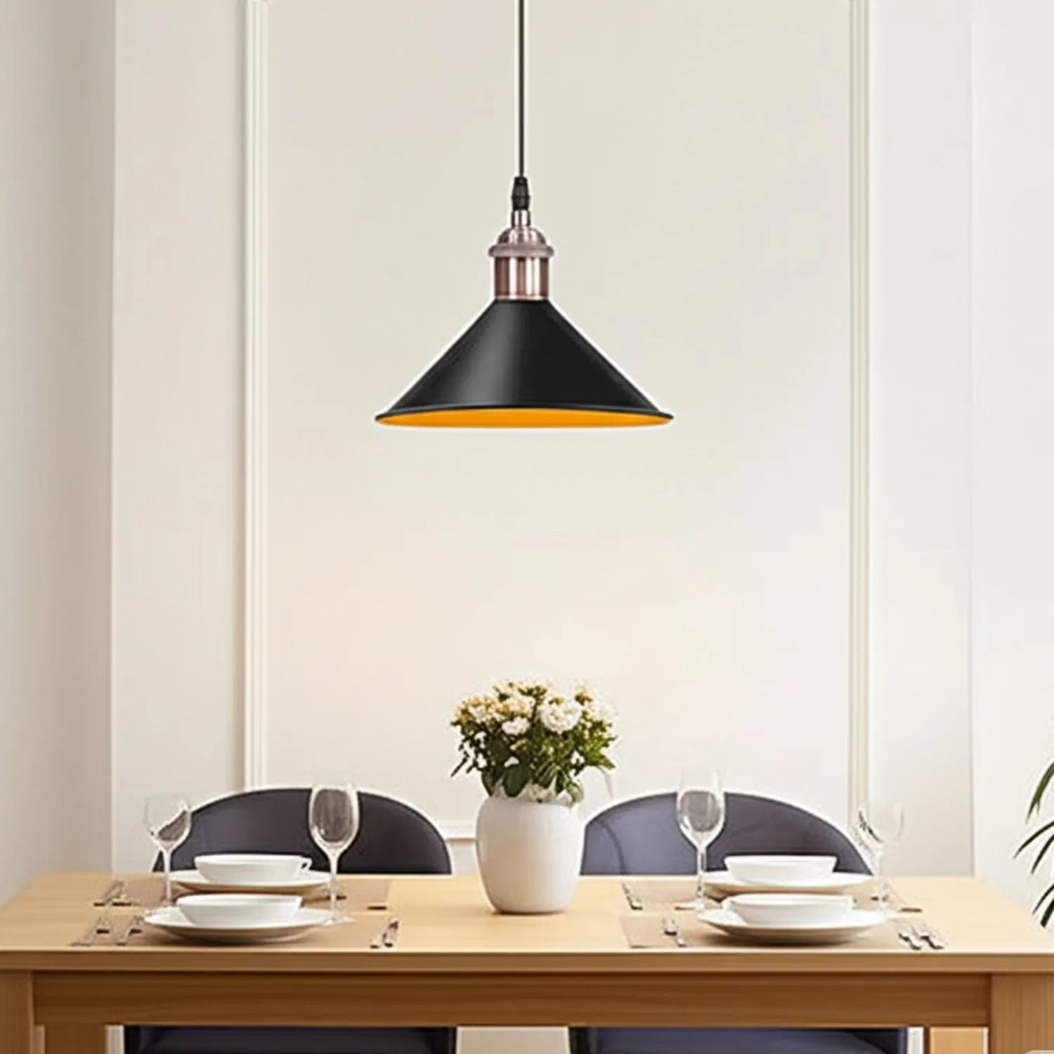 Dining room with a black pendant light, table setting, and white walls.