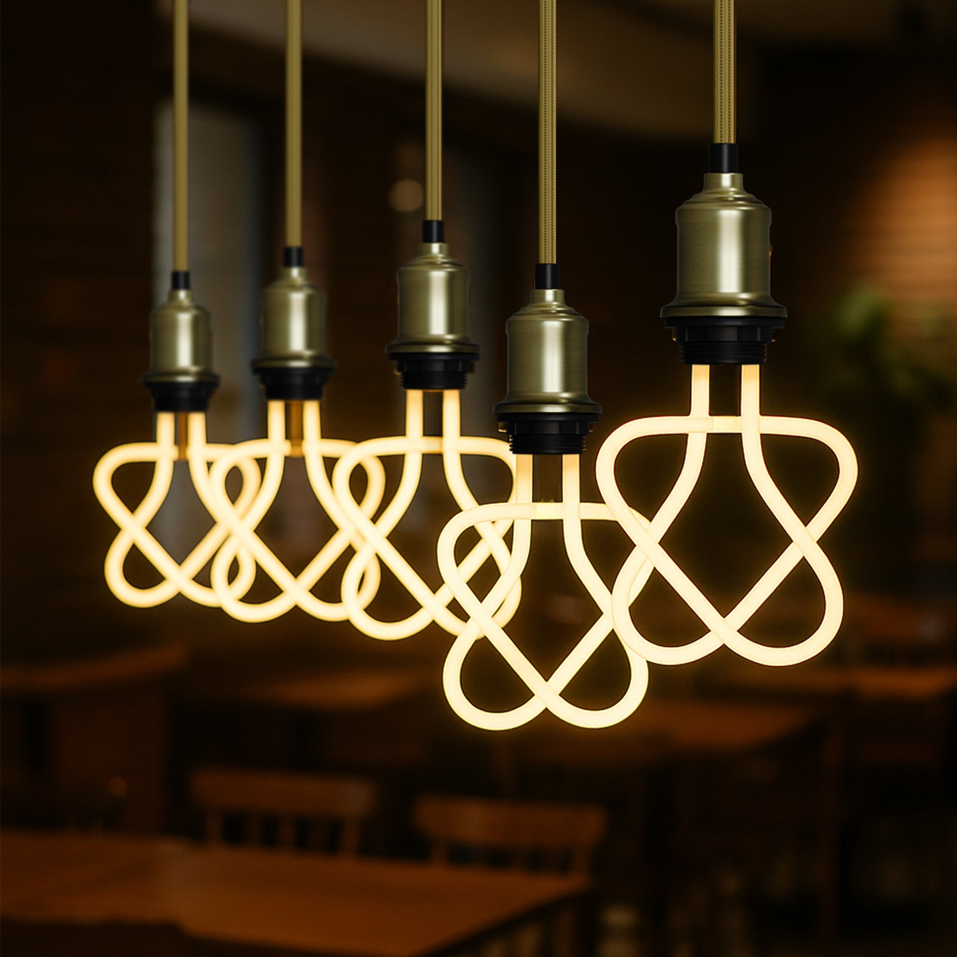 Decorative light bulbs with intricate designs hanging in a dark setting