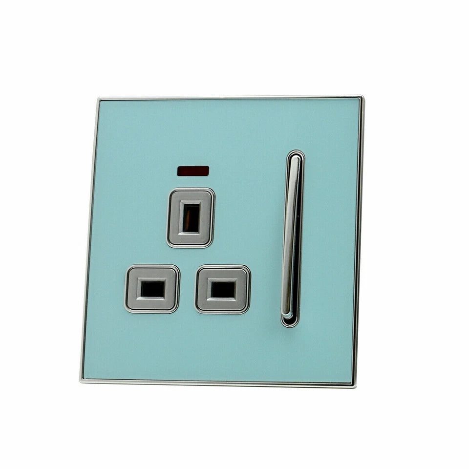 Decorative UK plug socket with a glossy blue face and satin gold inserts A full range of blue glossy plug sockets with gold inserts  Blue glossy decorative plug socket in a modern room