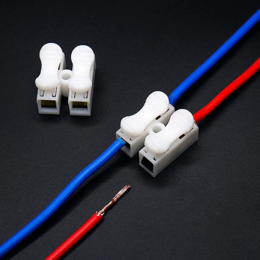 Dual push-in wire connector block joining electrical wires alongside a stripped red cable on dark background.