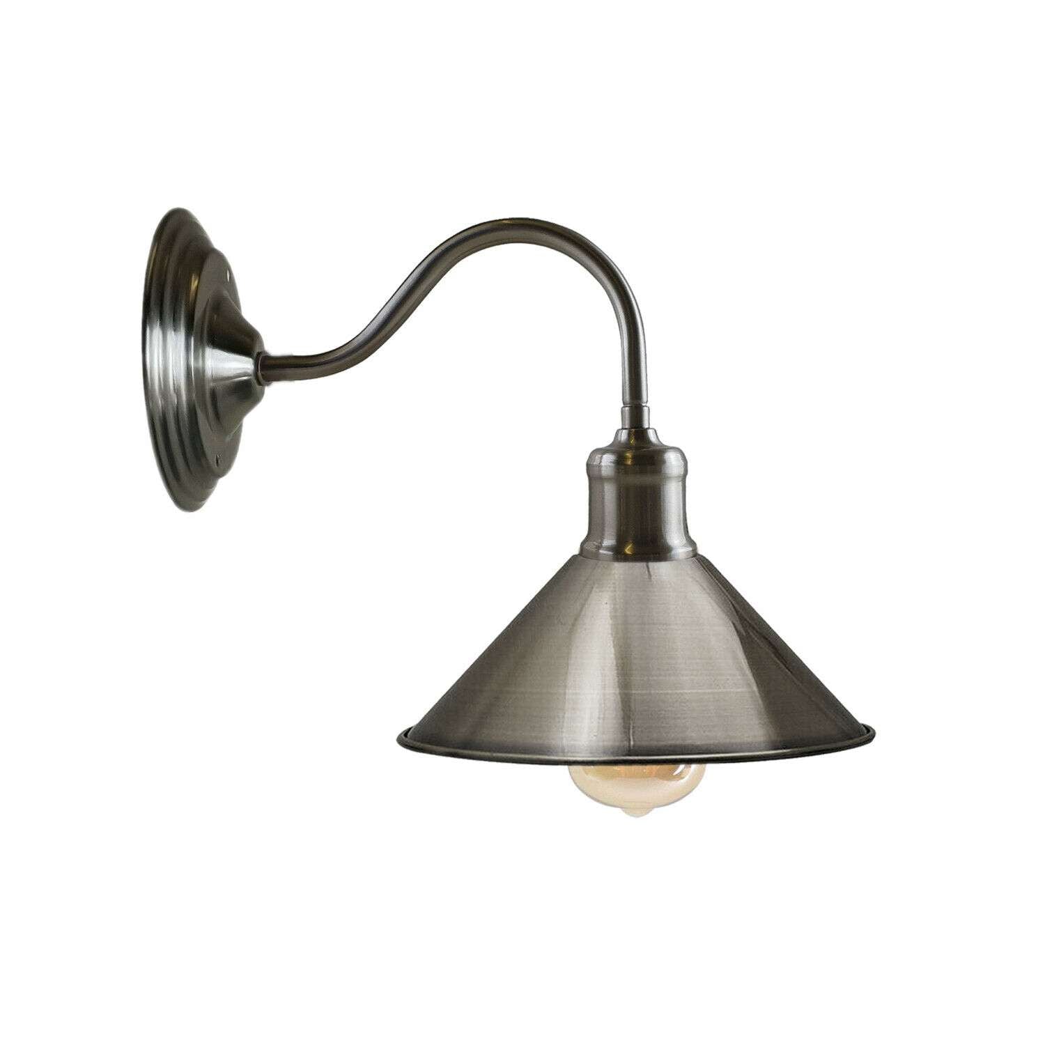 A black metal wall sconce with a conical shade mounted on a wall