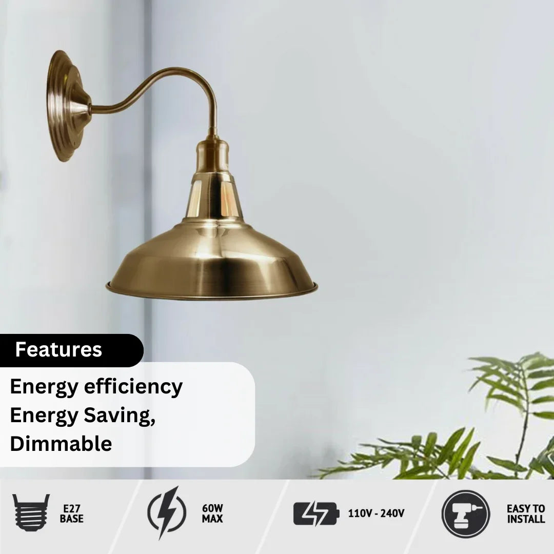 A brass wall sconce with a curved arm and a dome-shaped shade, shown against a light gray wall with a plant in the corner. Text overlays highlight features like energy efficiency, dimmable, E27 base, 60W max, 110V-240V, and easy to install.