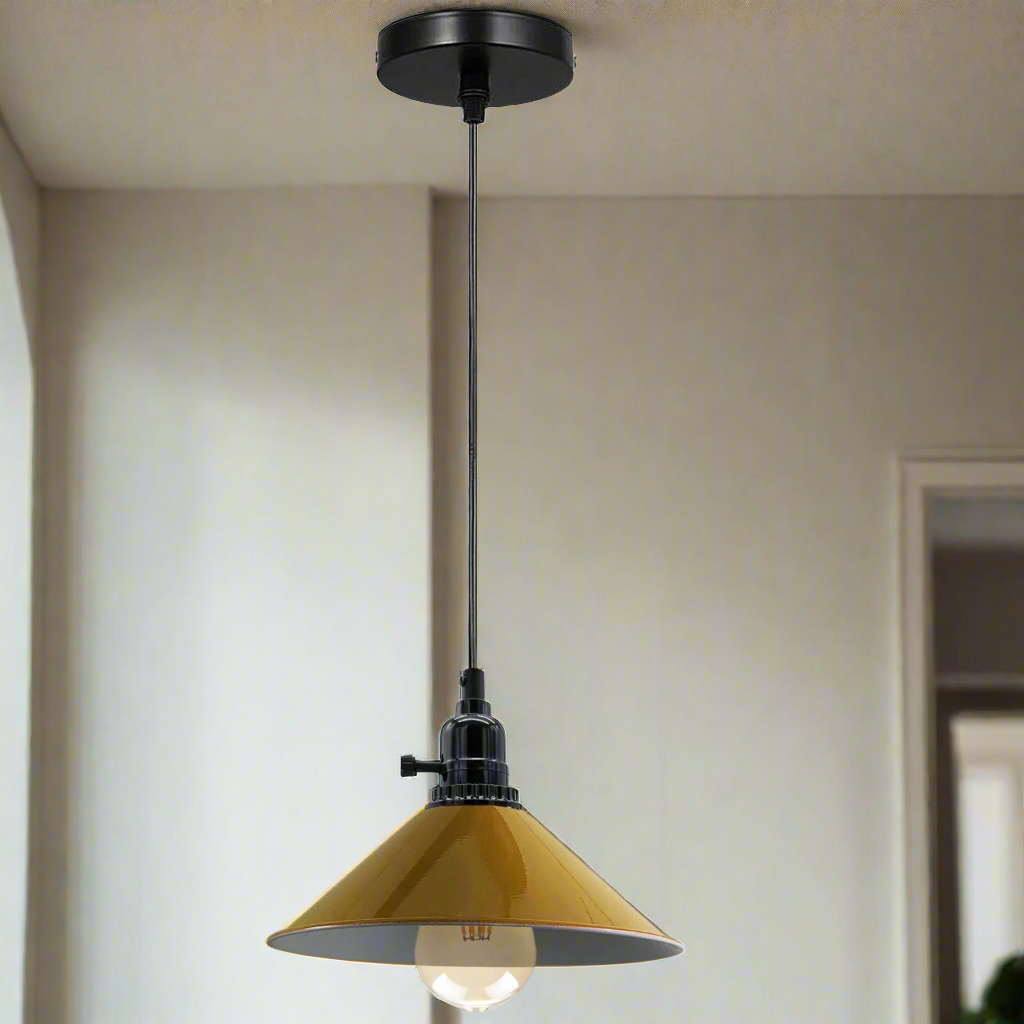Pendant light with yellow glass shade and black metal fixture hanging from ceiling.