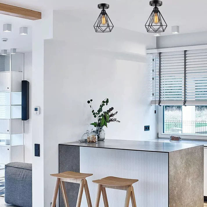 Modern kitchen with island, stools, and decorative elements.