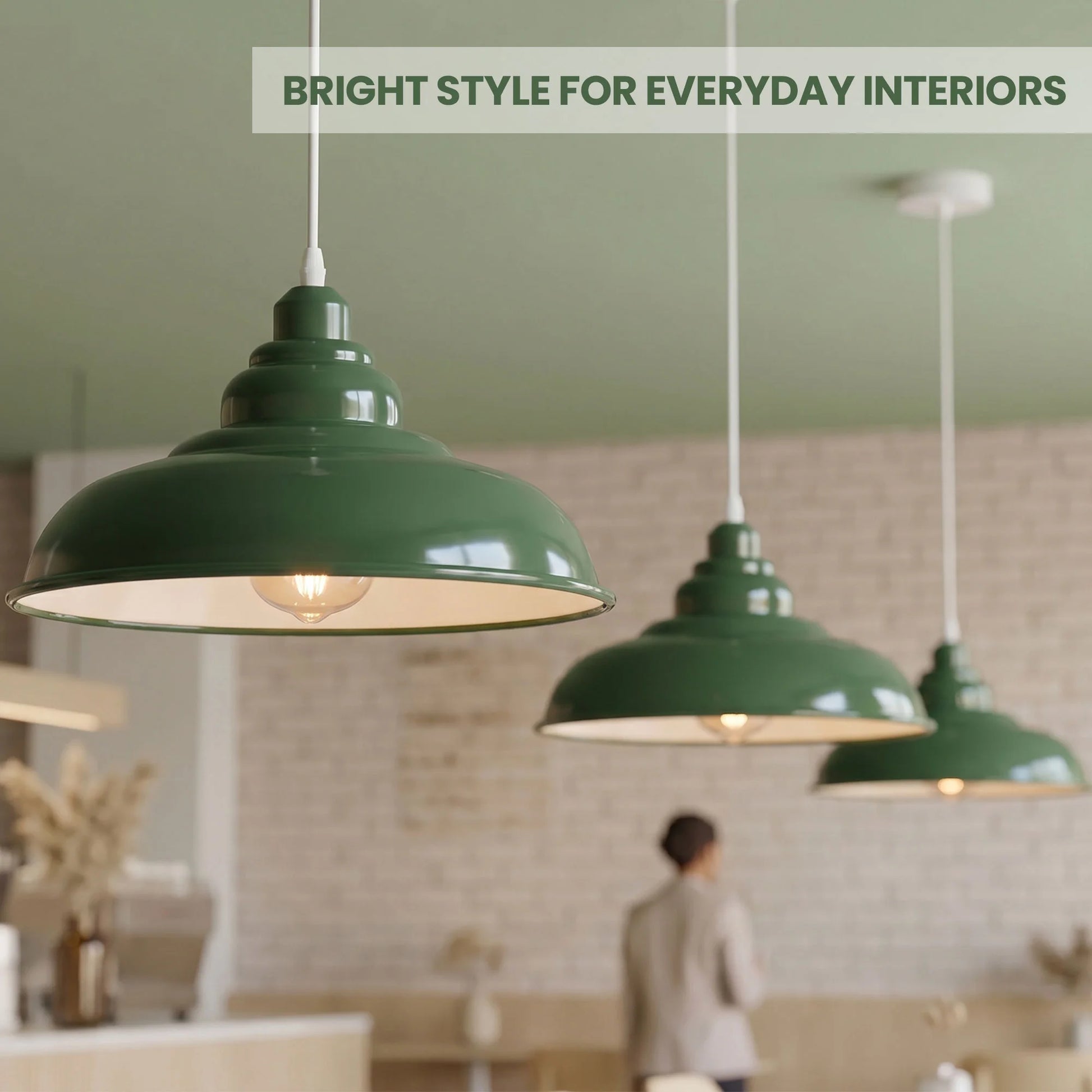 Green pendant lights in a room with a person and decor elements.