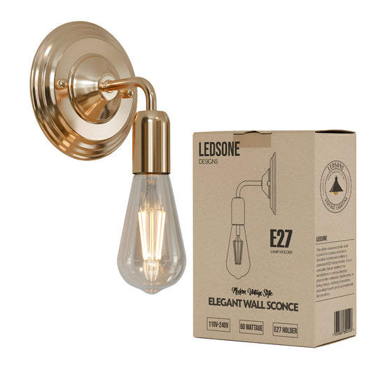 Gold wall sconce with clear light bulb and Ledstone packaging on a white background