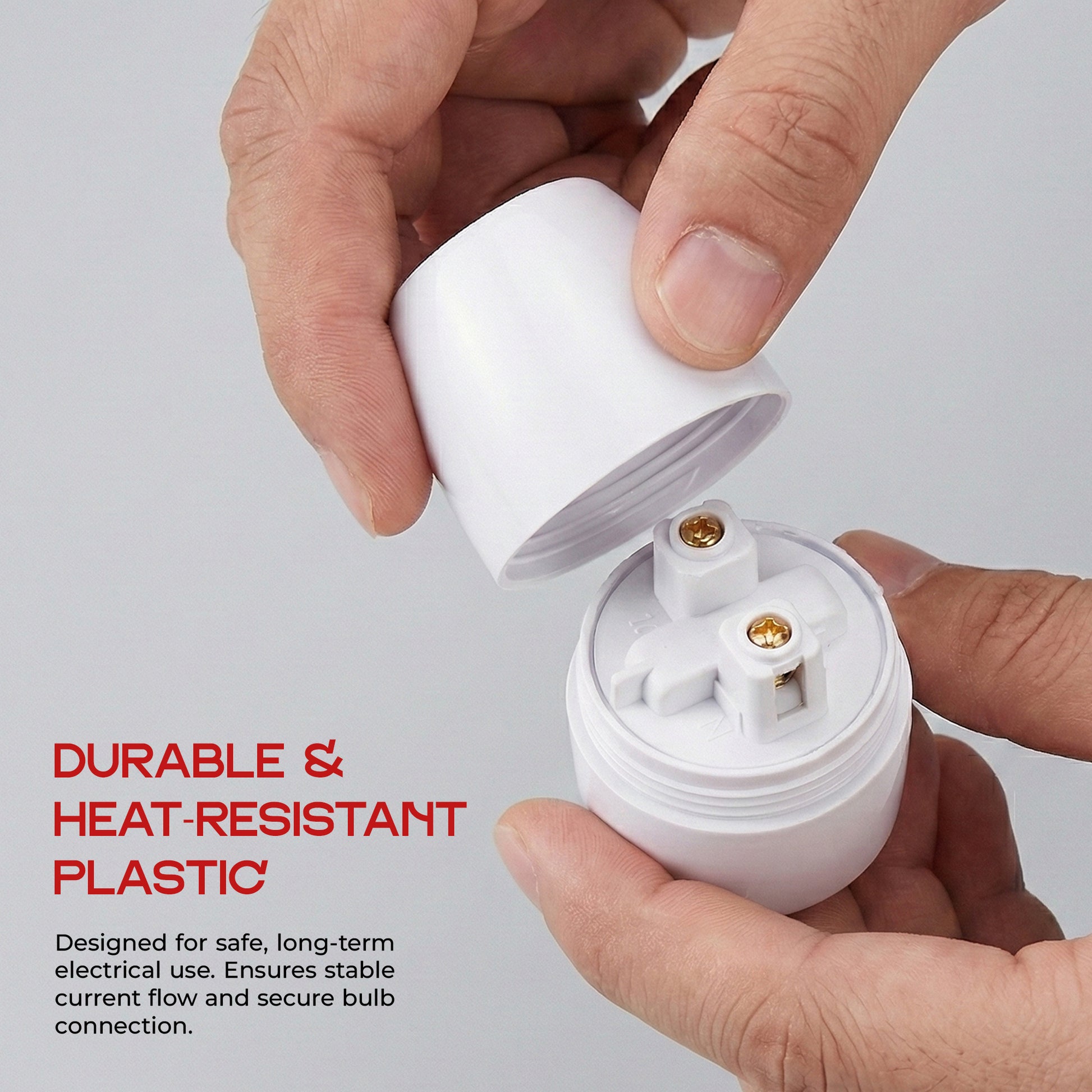 Person holding a white light bulb socket with text about durable and heat-resistant plastic.