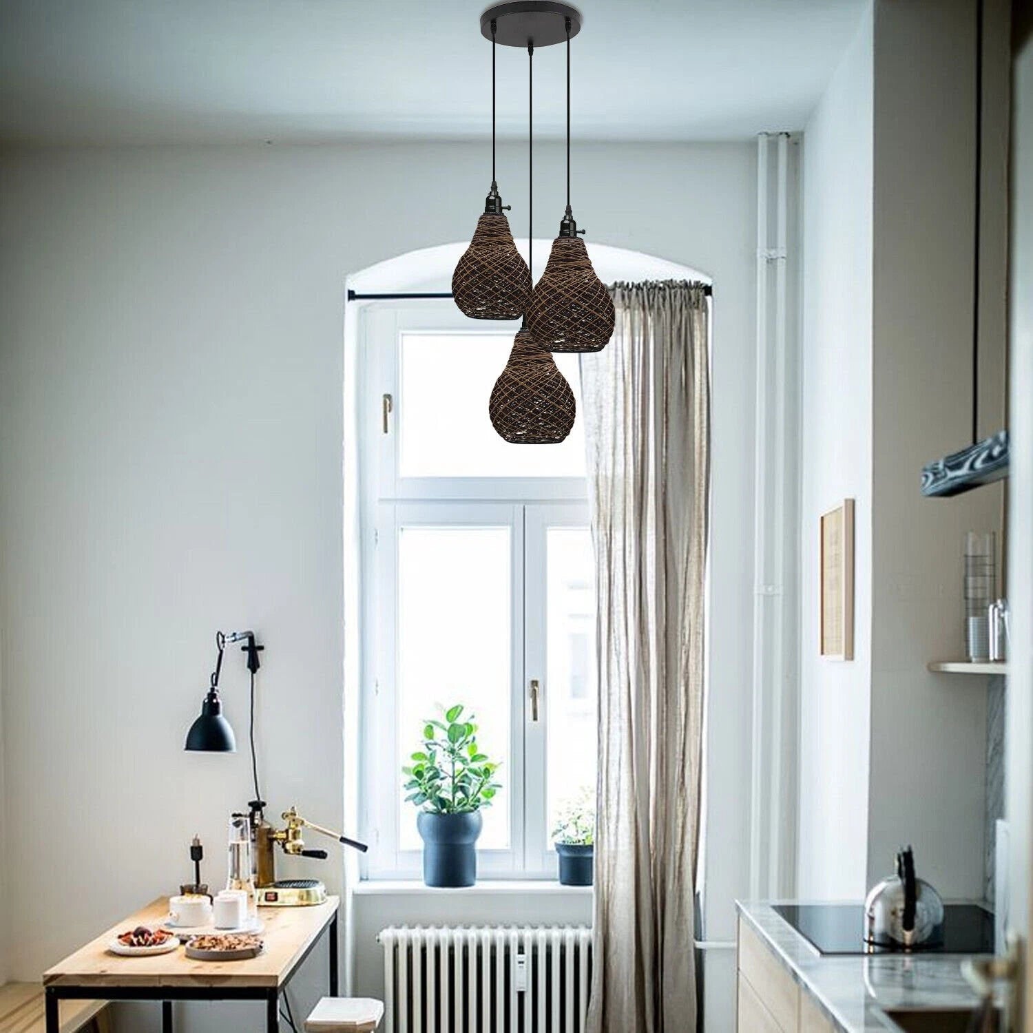 Three vase-shaped rattan wicker pendant lights hang from the ceiling over a kitchen table