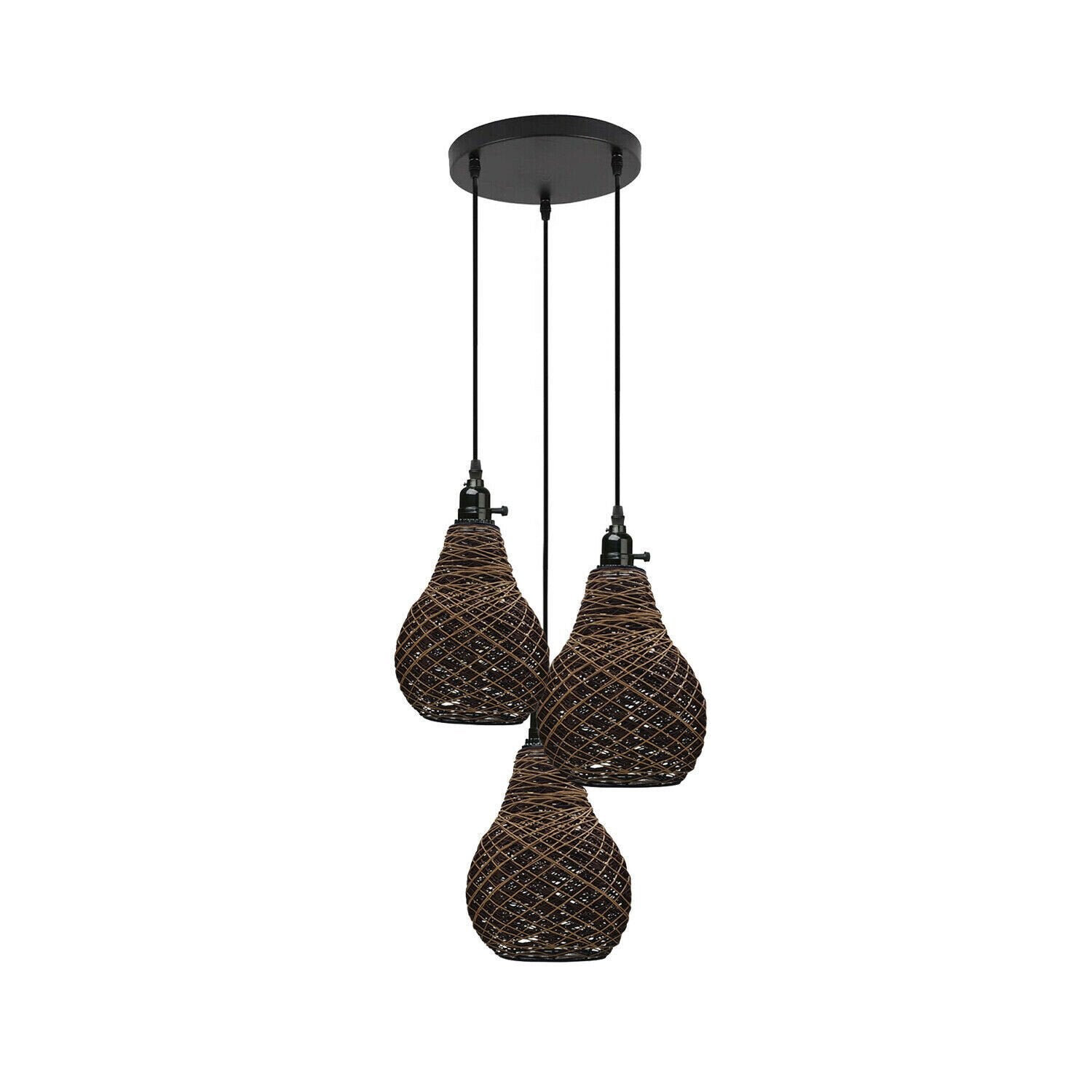 A cluster of three vase-shaped rattan wicker ceiling pendant lights with black suspension cords.