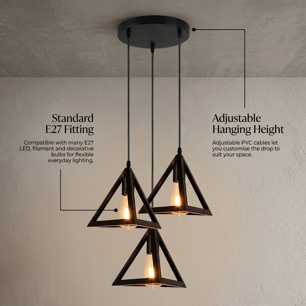 Three-light triangular pendant ceiling fixture with black metal frames and warm exposed bulbs, shown hanging against a textured wall with callout text for E27 fitting and adjustable hanging height.