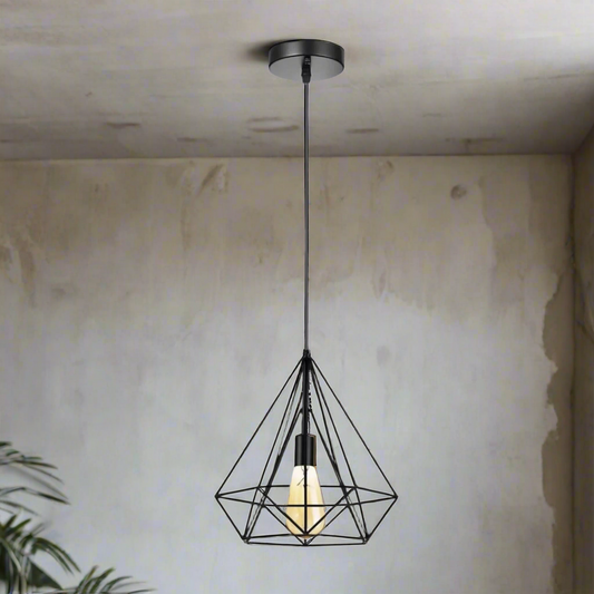 Black geometric pendant light hanging from a ceiling with a neutral wall background