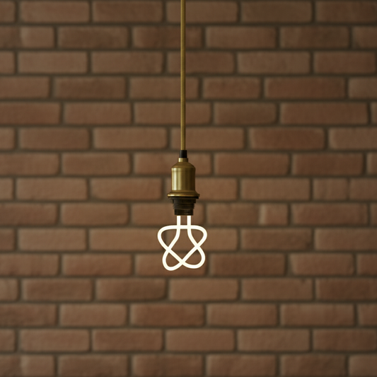 Decorative light bulb with unique design against a brick wall background