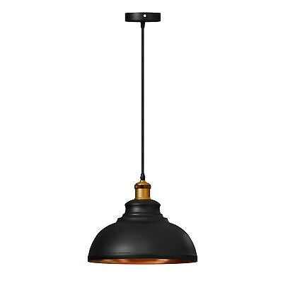 Two people seated at a table with a pendant light above them creating a warm ambiance. The setting appears to be indoors, possibly in a home or cafe environment.