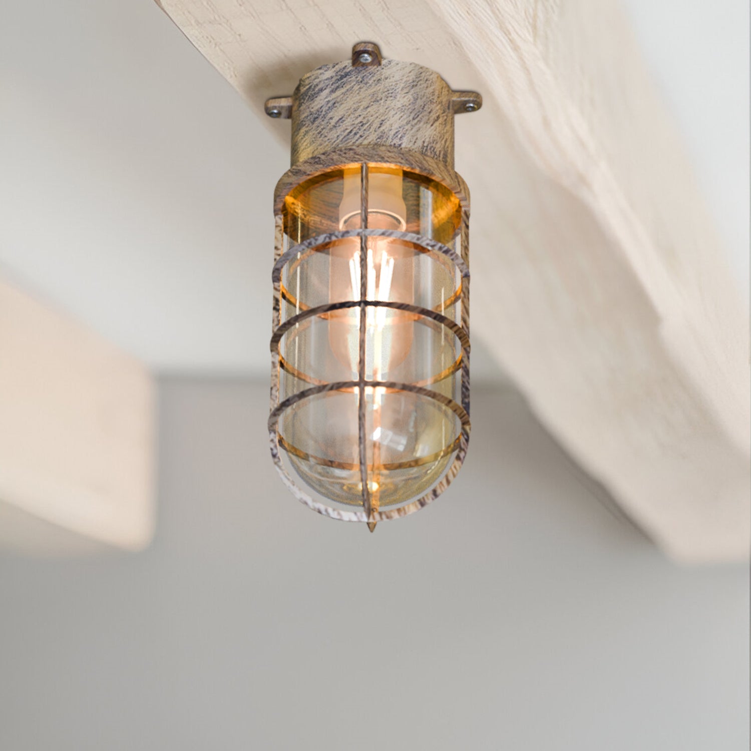  A retro oval bulkhead cage wall ceiling mount light with a frosted glass cover and a Brushed Copper metal base, illuminated with one bulb.