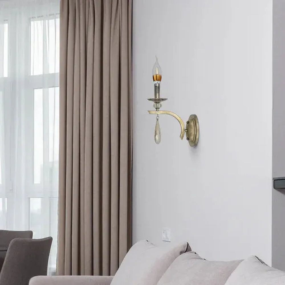 gold wall light with an LED candle bulb in a living room