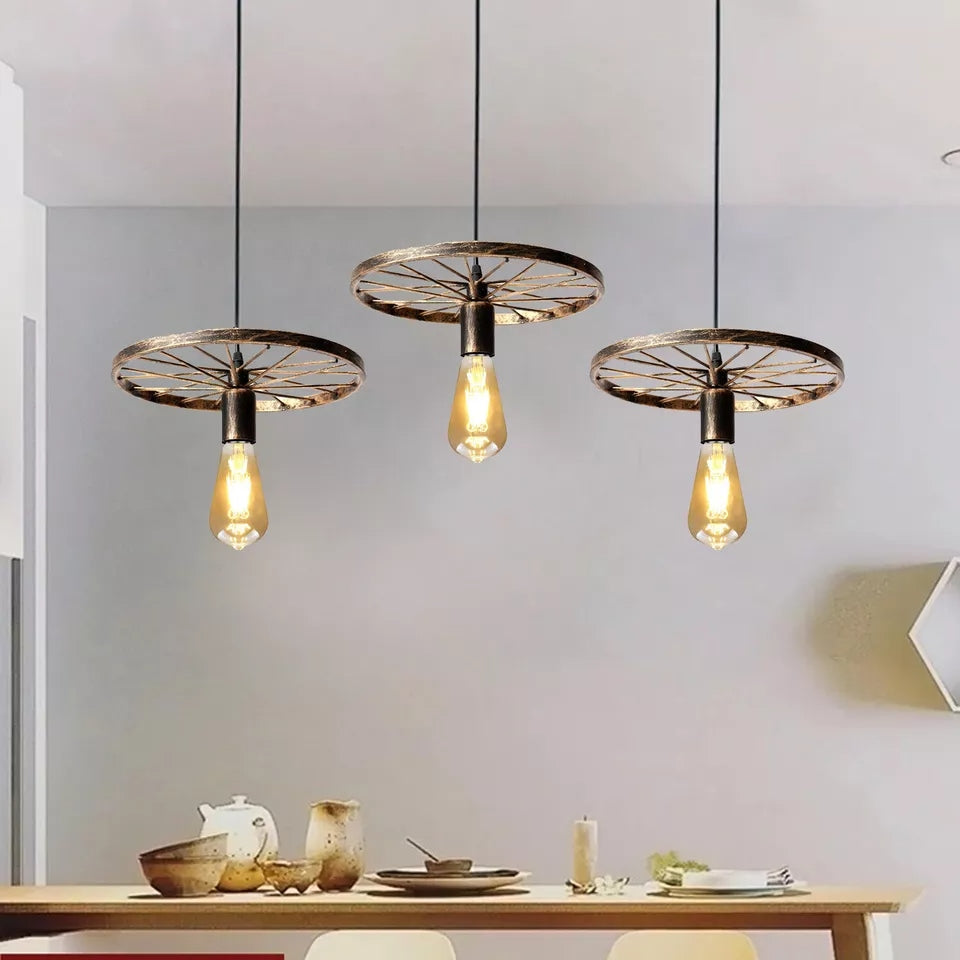 Three pendant ceiling lights with a vintage bike wheel 