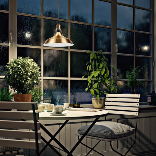 Brass metal pendant light hanging above kitchen island